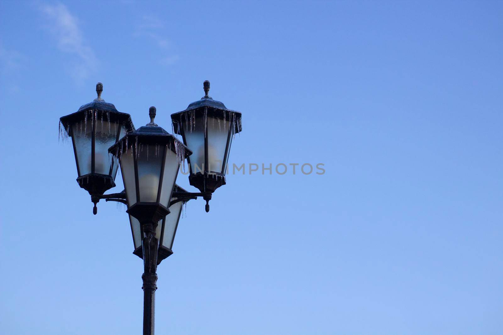 Street light on background of blue sky. Urban evening photo with copy space.