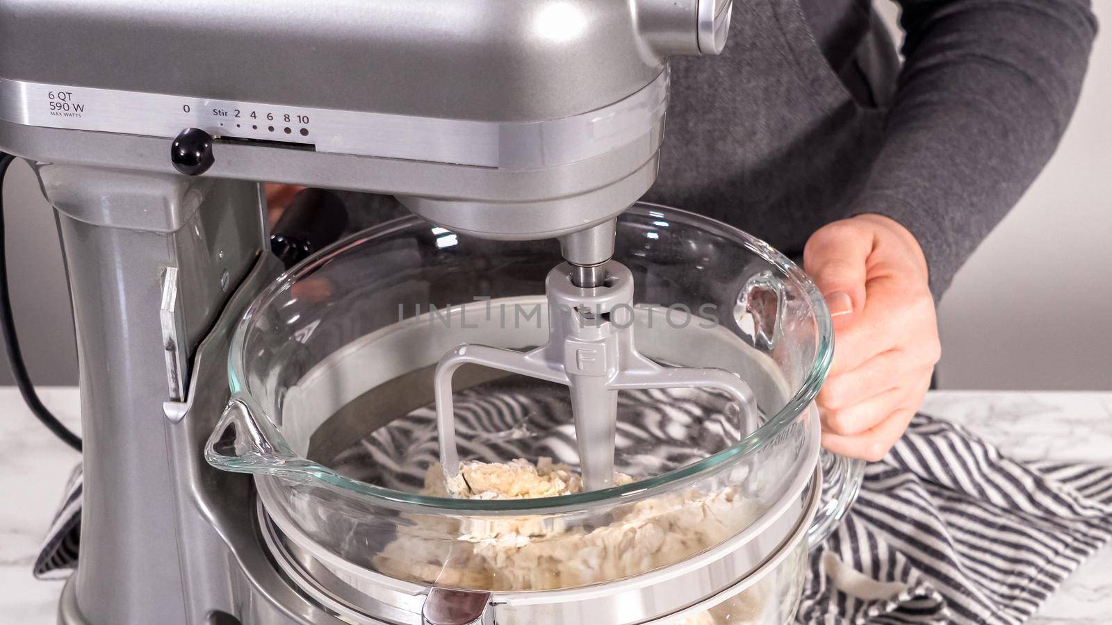 Step by step. Mixing ingredients in kitchen mixer to bake homemade brioche buns.