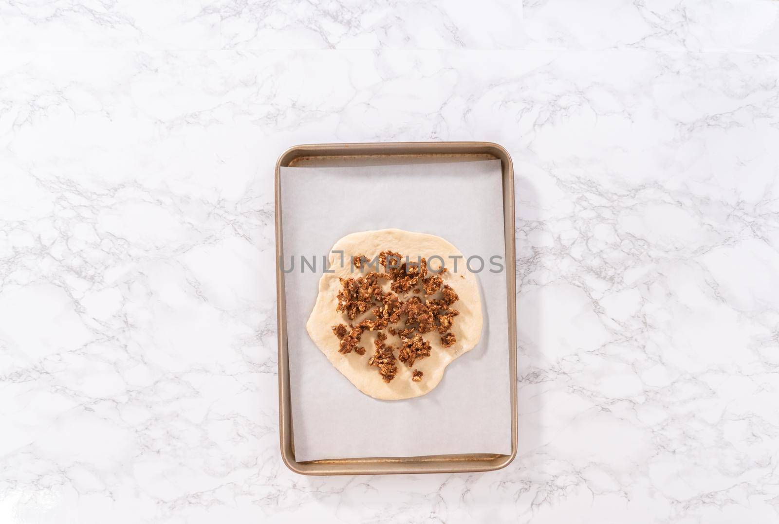 Flat lay. Preparing cinnamon dessert pizza on a baking sheet lined with parchment paper.