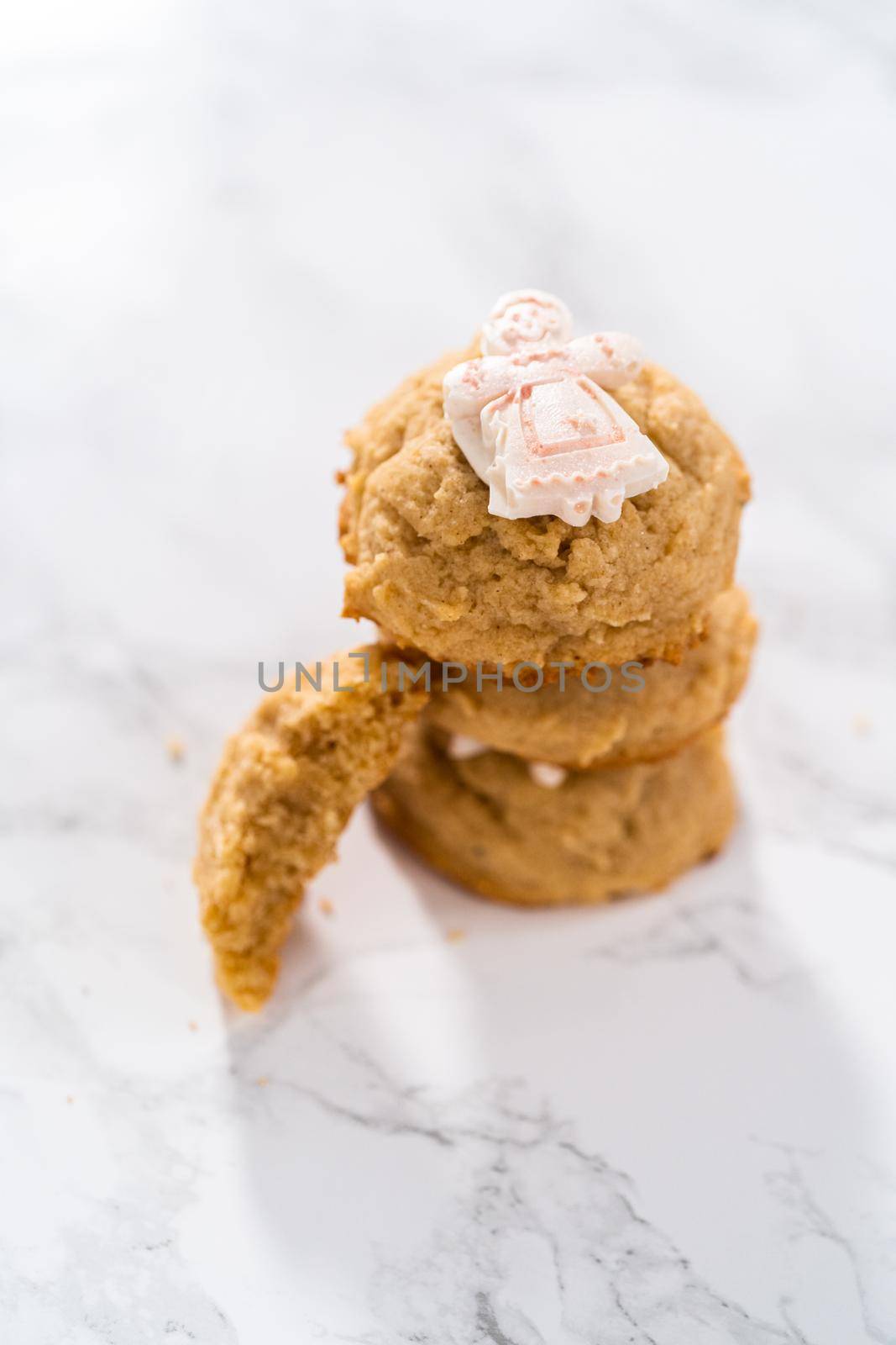 Eggnog cookies with a chocolate gingerbread man in a stack.