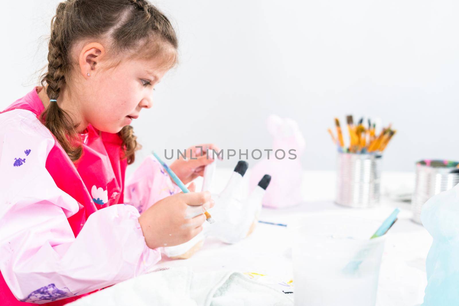 Little girl working on her art project for distance learning at home during COVID-19 pendemic.