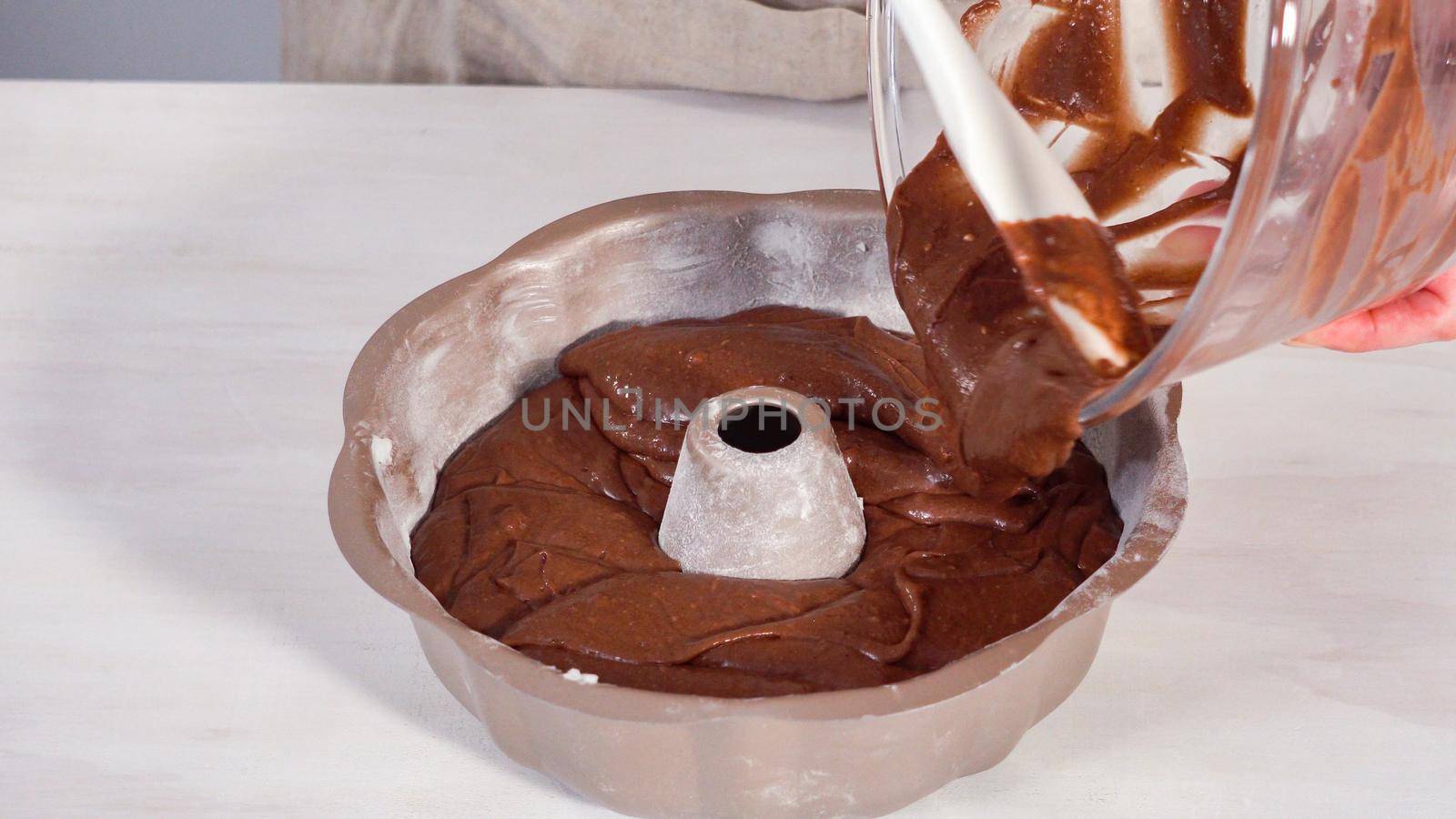 Step by step. Chocolate cake batter in a metal bundt cake pan ready for baking.