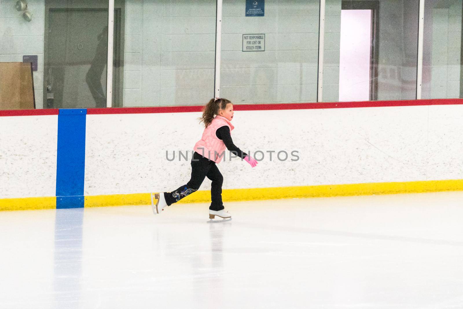 Little skater practicing her elements at the morning figure skating practice.