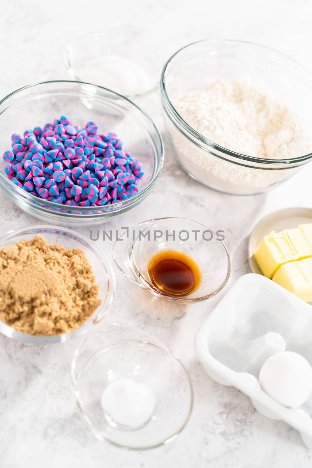 Ingredients in glass mixing bowls to bake unicorn chocolate chip cookies.