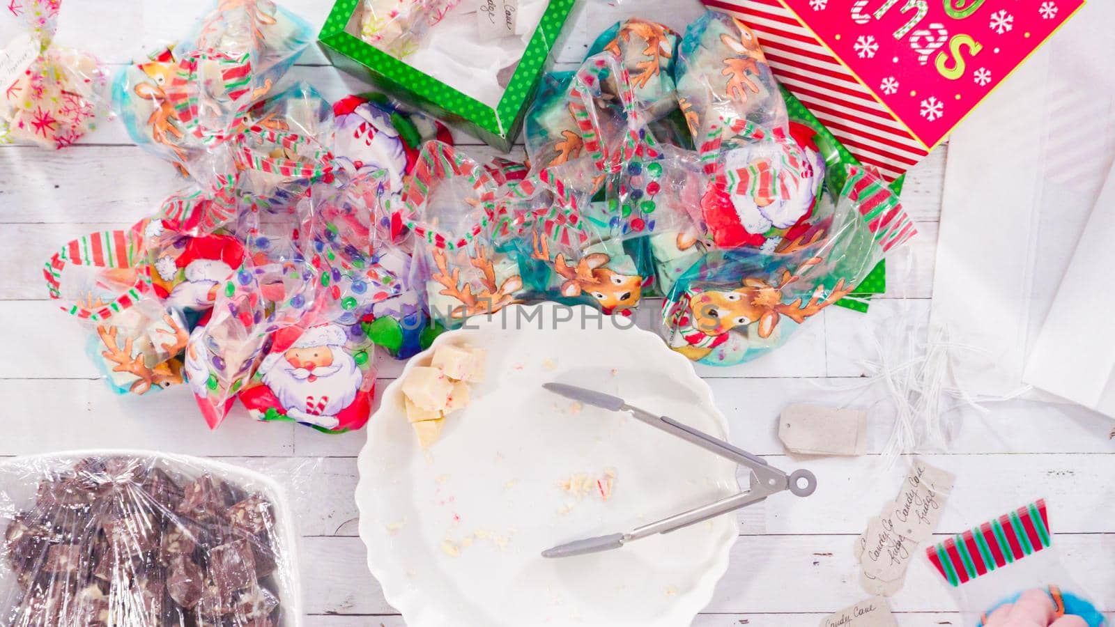 Flat lay. Step by step. Packaging homemade candy cane fudge into small gift bags.