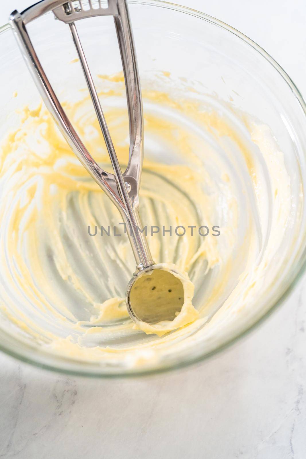 Filling metal bundt cake pan with cake butter to bake red velvet bundt cake with cream cheese glaze