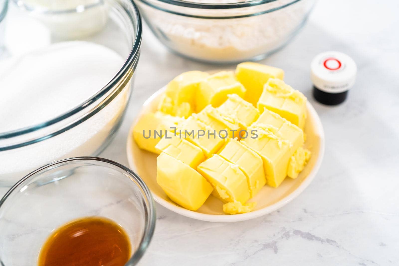 Measured ingredients in glass mixing bowls to bake red velvet bundt cake with cream cheese glaze.