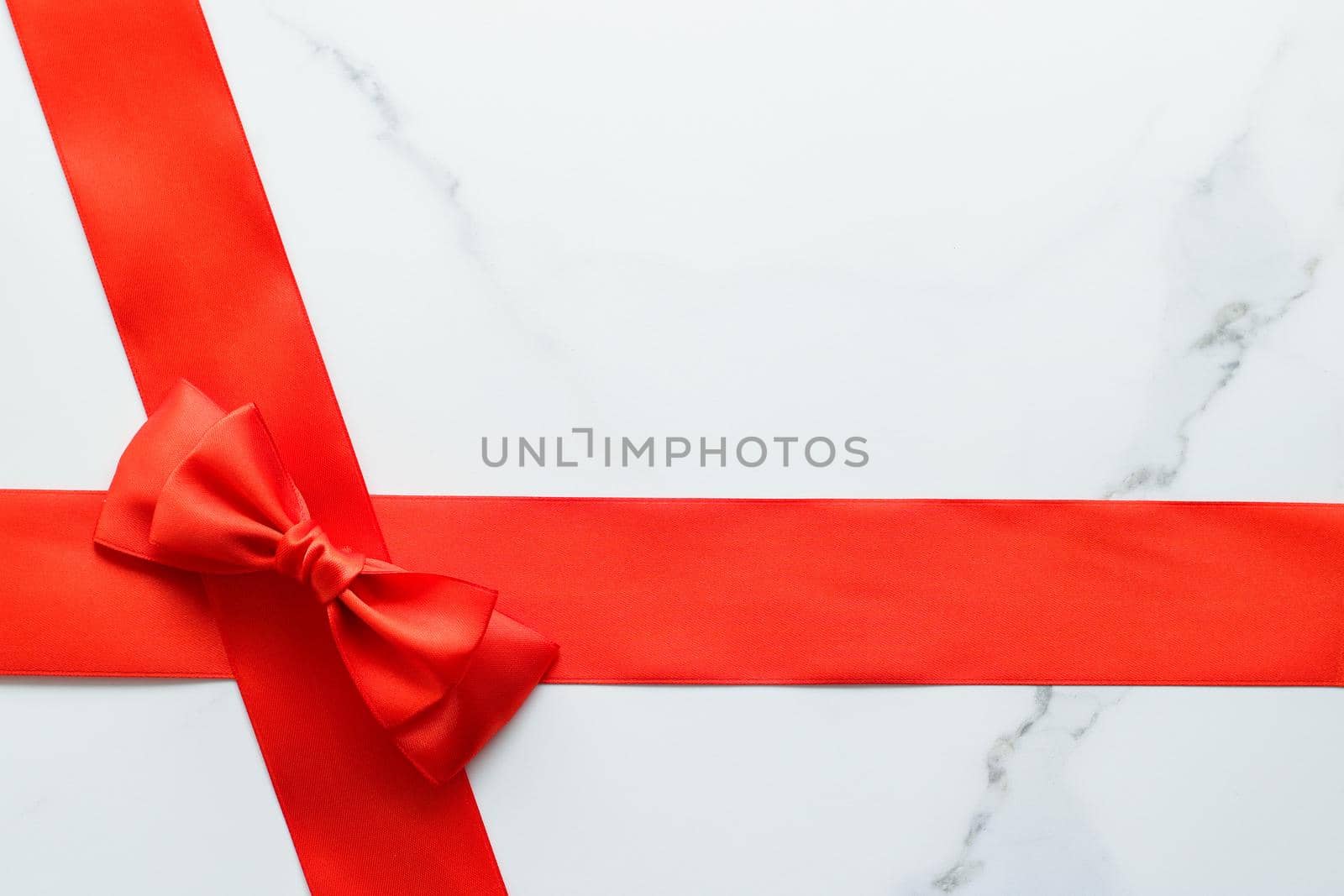 Holiday decor, feminine design and flatlay concept - Red silk ribbon on marble, top view