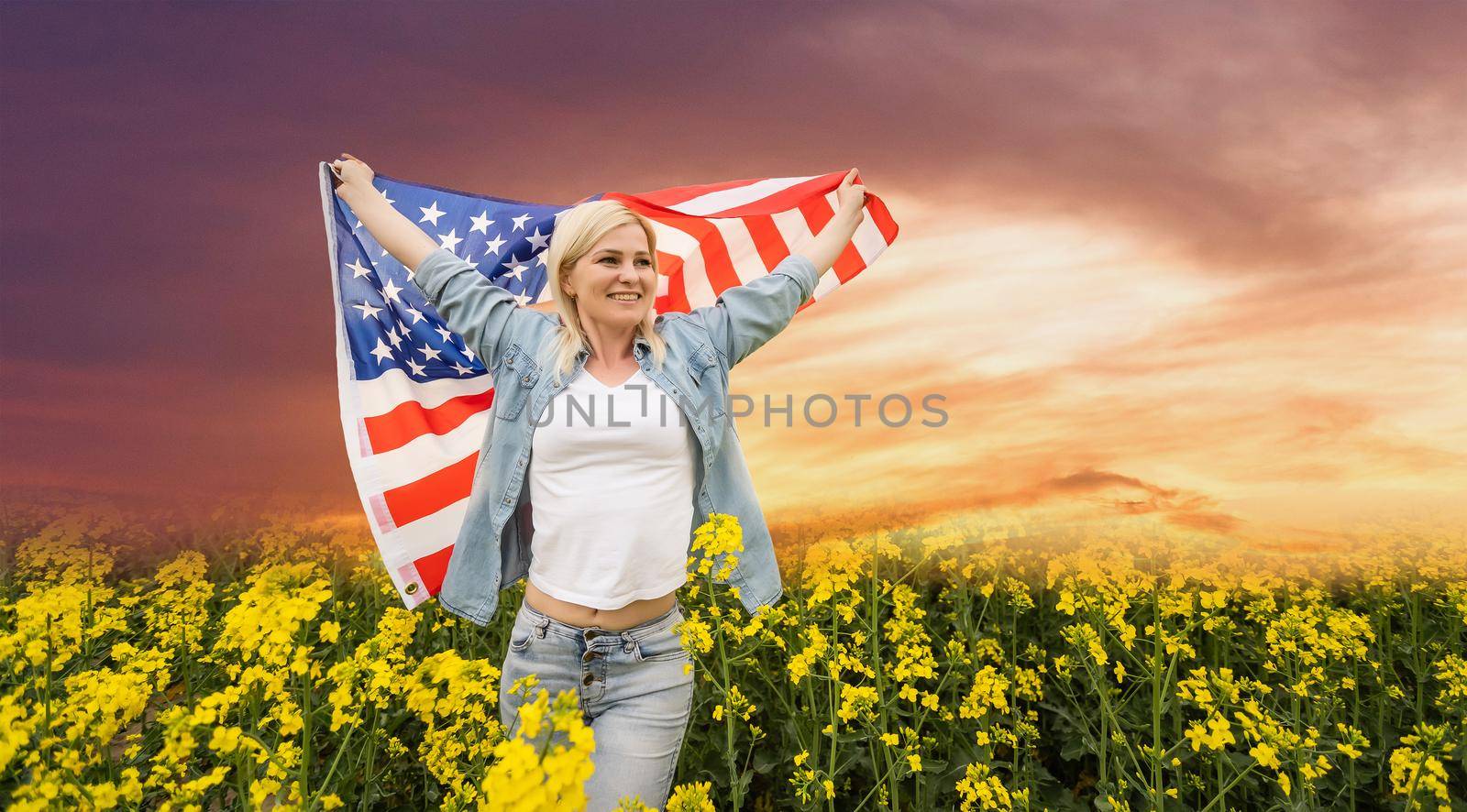 Young cute woman holding an united states flag.