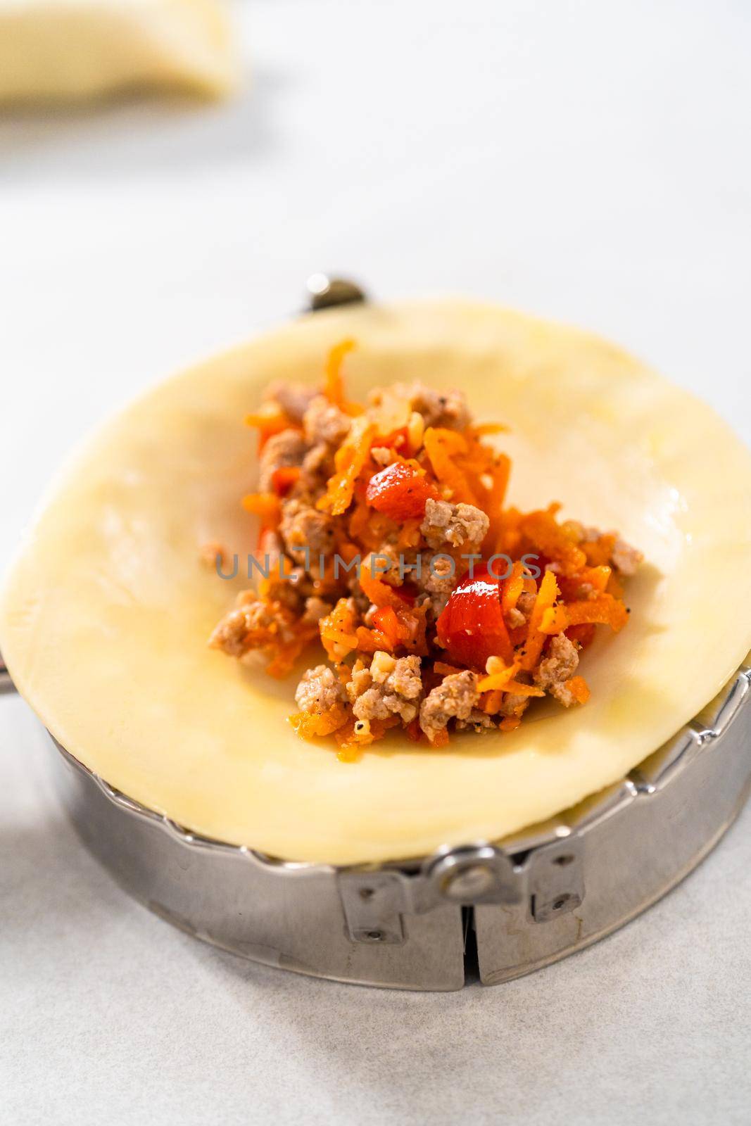 Flat lay. Filling empanada dough with turkey filling to make turkey empanadas.