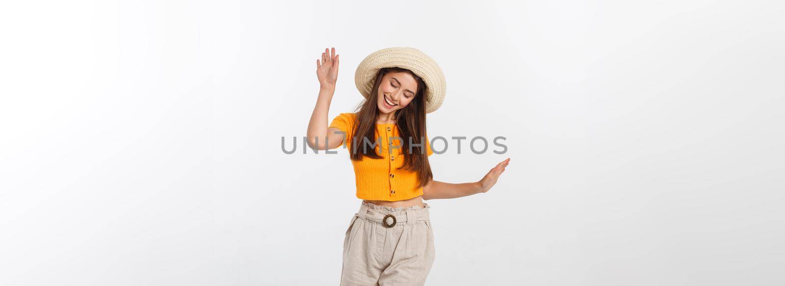 Cool hipster portrait of young stylish teen girl showing her hands up, positive mood and emotions,travel alone. Isolated over grey background.