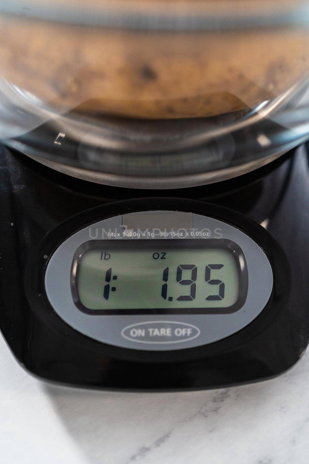 Pressure Cooker Baked Potatoes. Measuring raw potatoes in a glass mixing bowl on the kitchen scale.