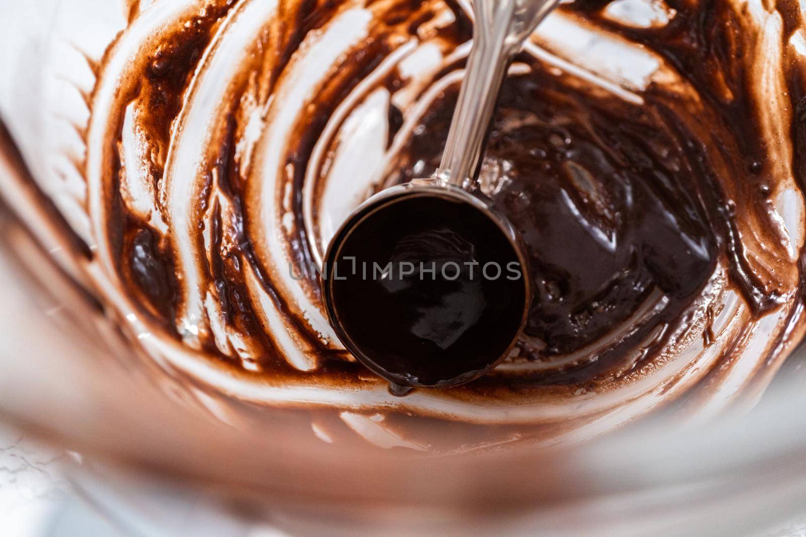 Baking chocolate cupcakes. Scooping chocolate cupcake batter into a cupcake pan.