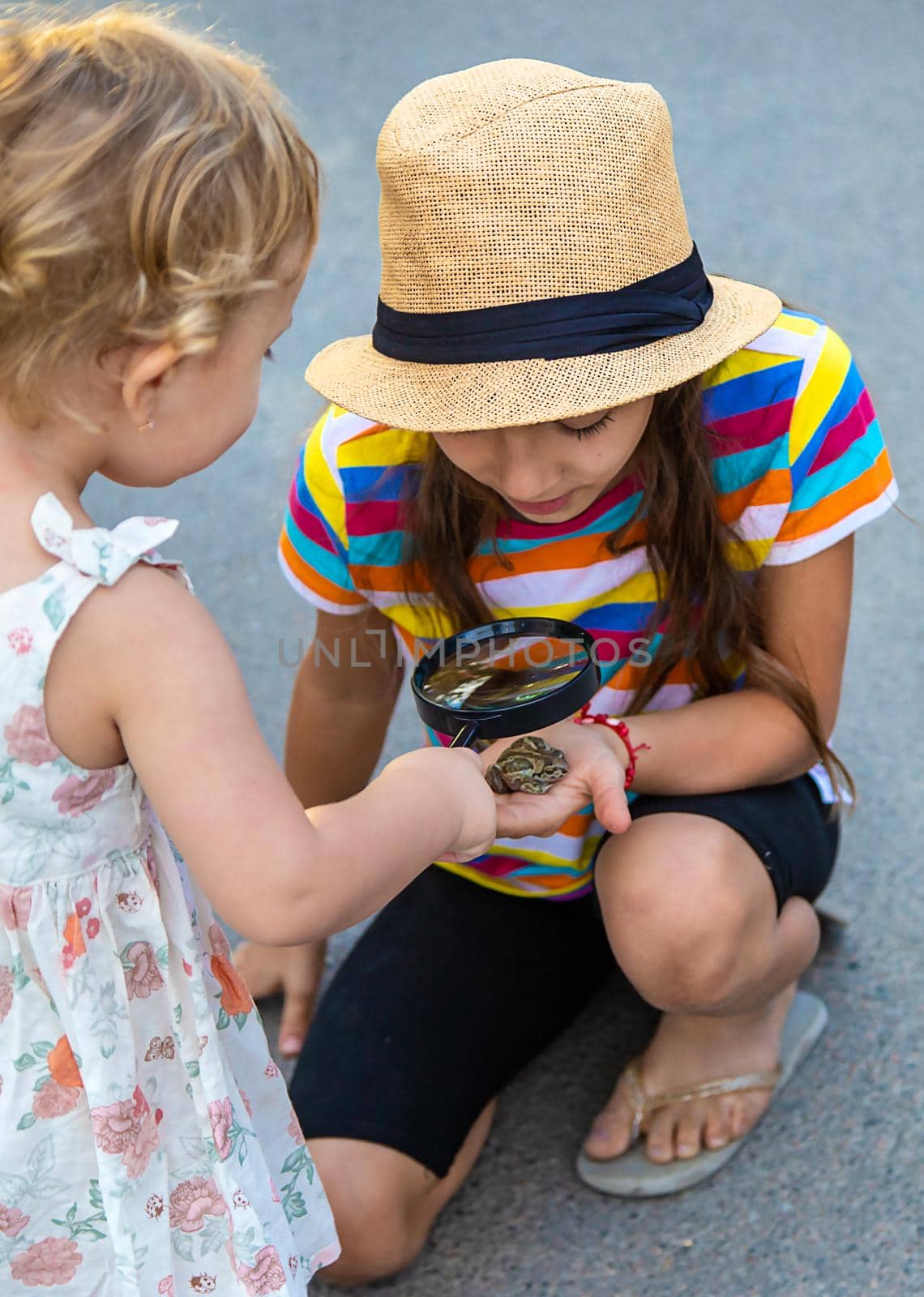 The child is playing with the frog. Selective focus. Kid.