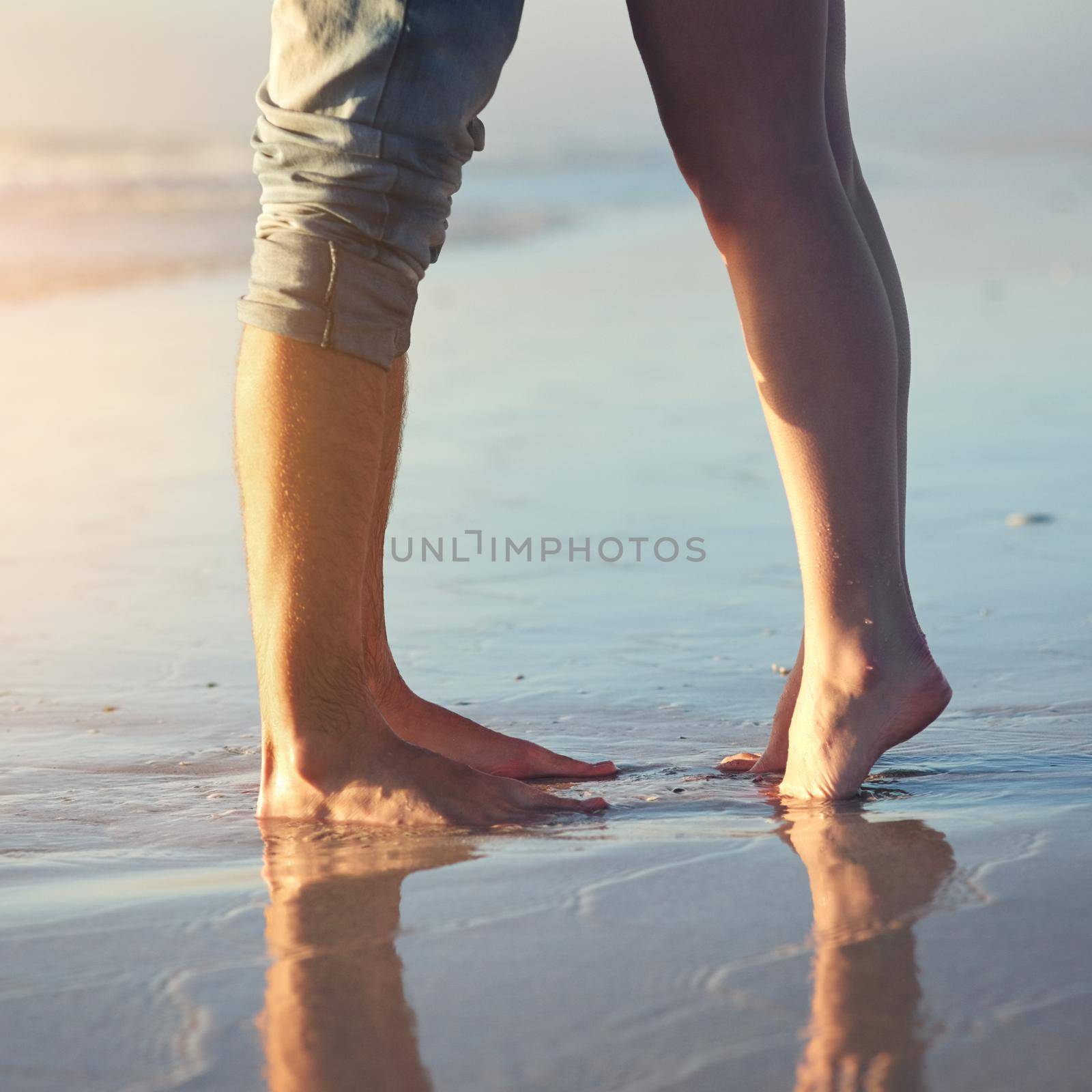 May this love last forever. a couple standing on the beach. by YuriArcurs