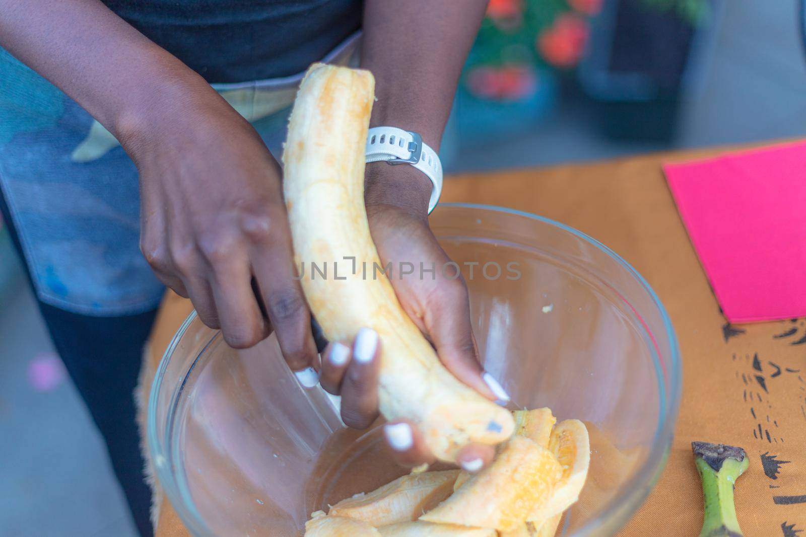 woman chef preparing african caribbean food with plantain plane tree fruit