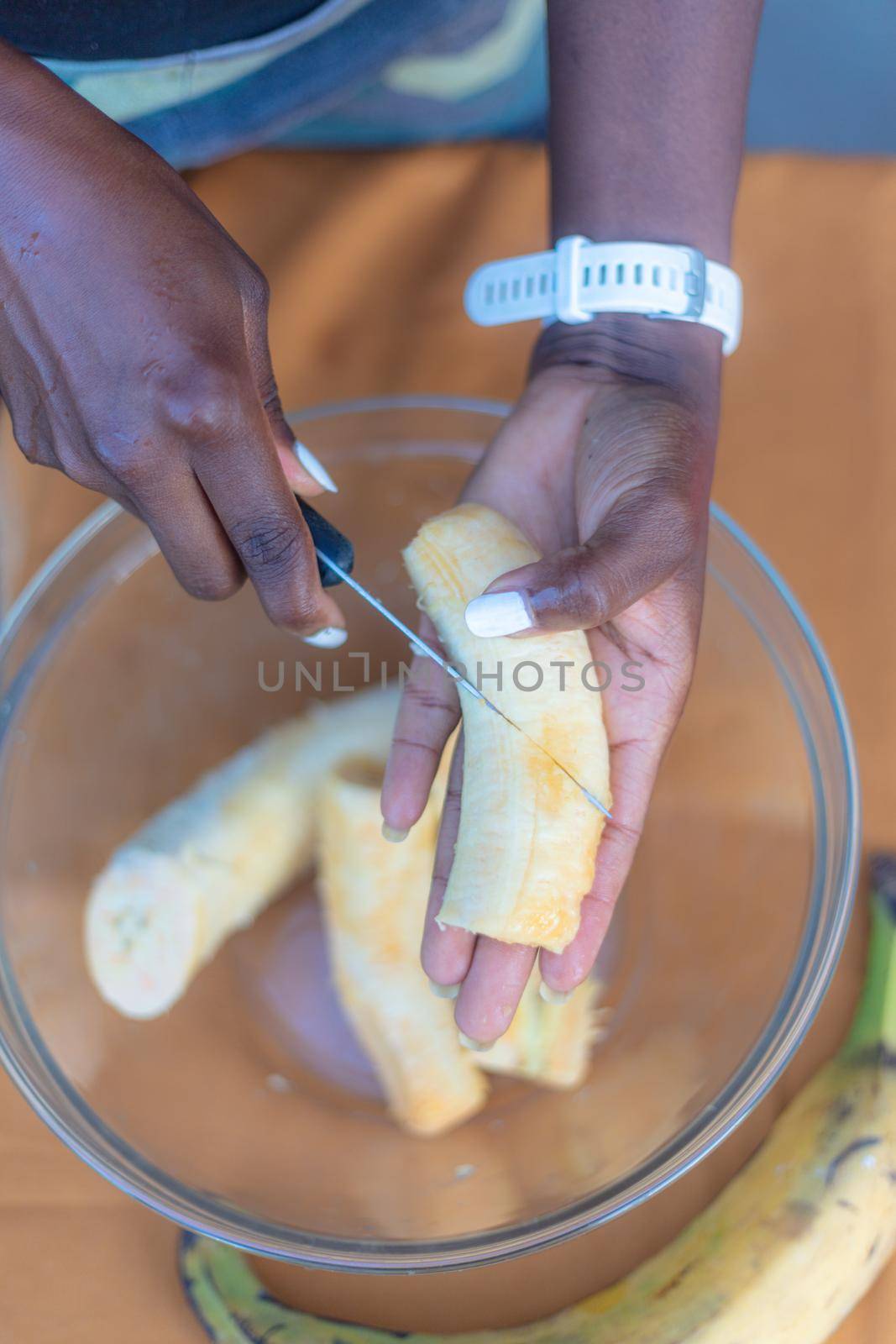 woman chef preparing african caribbean food with plantain plane tree fruit