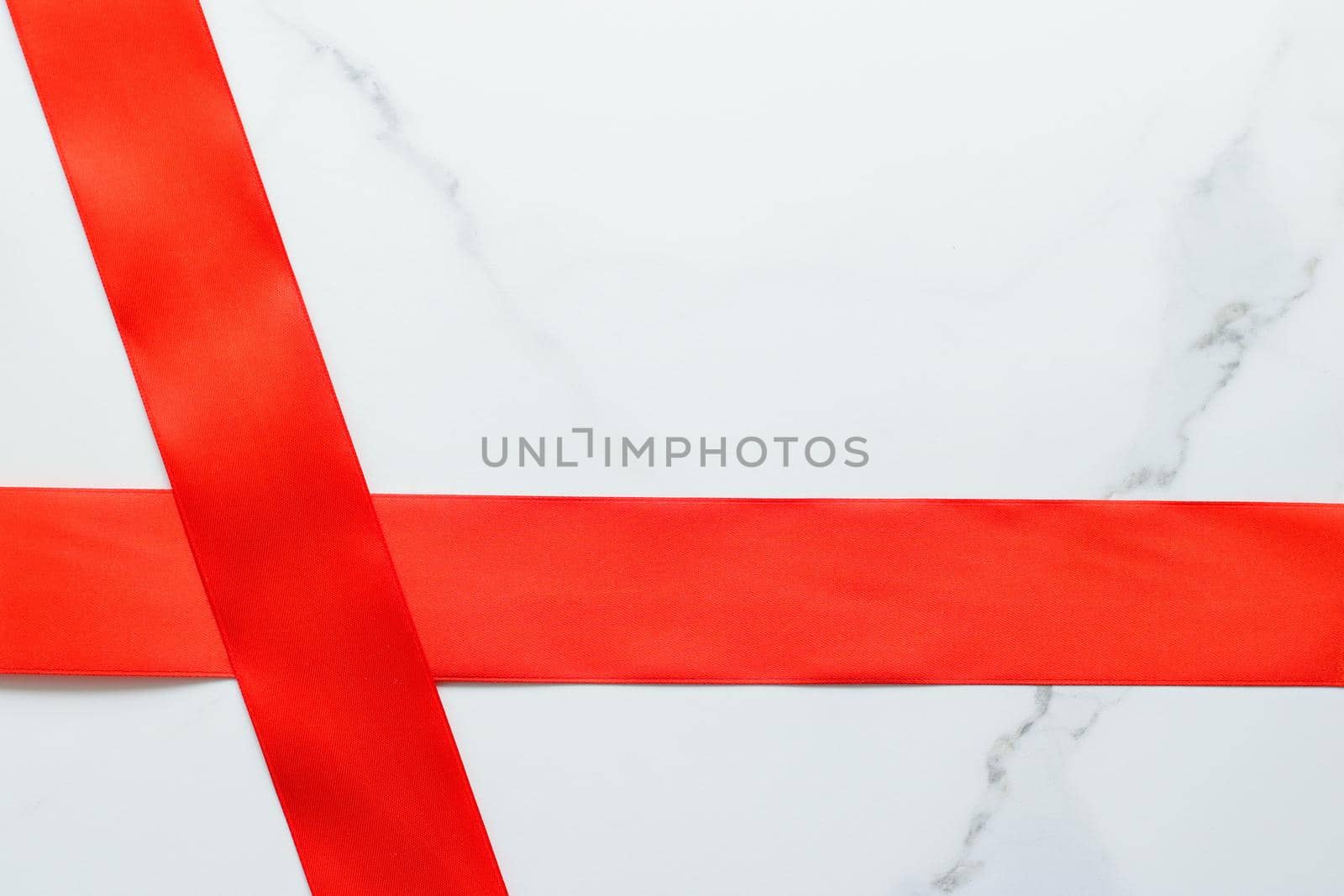 Holiday decor, feminine design and flatlay concept - Red silk ribbon on marble, top view