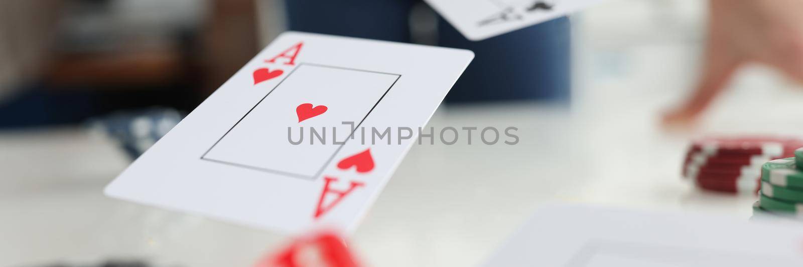 Playing cards aces and dice flying over gaming table in casino closeup. Luck in poker concept