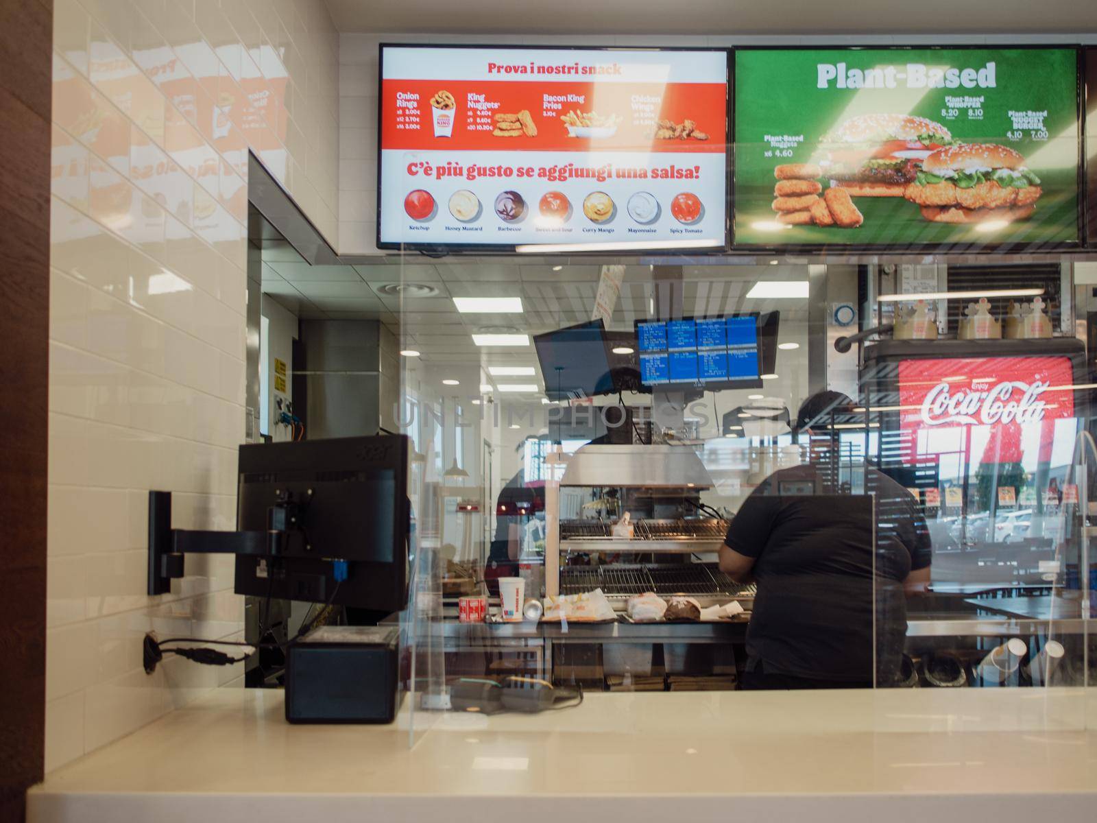 Milan, Italy - July 2020 customers at the counter picking the orders at the burger king by verbano