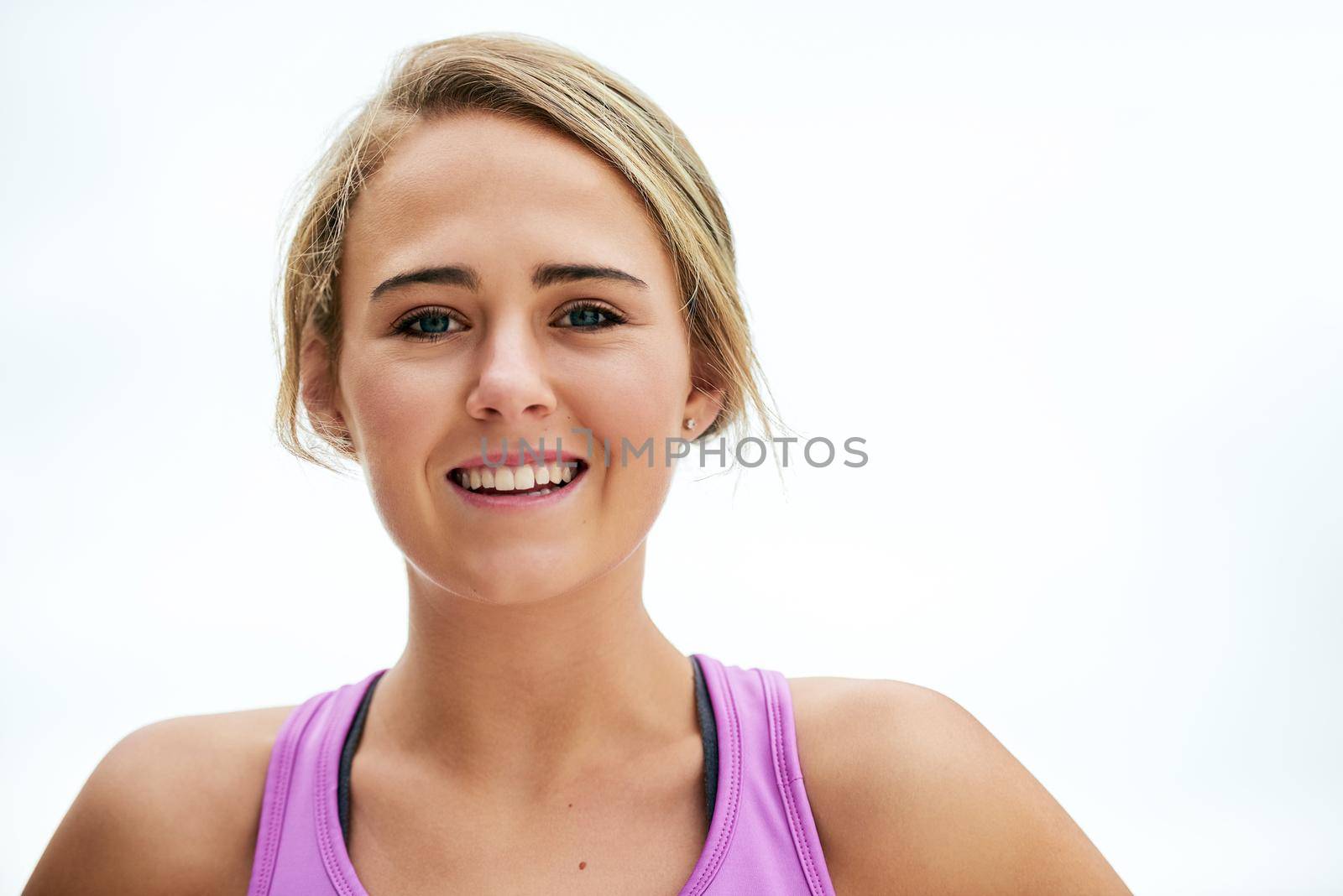 Getting fit gets me in a good mood. Closeup shot of a young woman standing outside