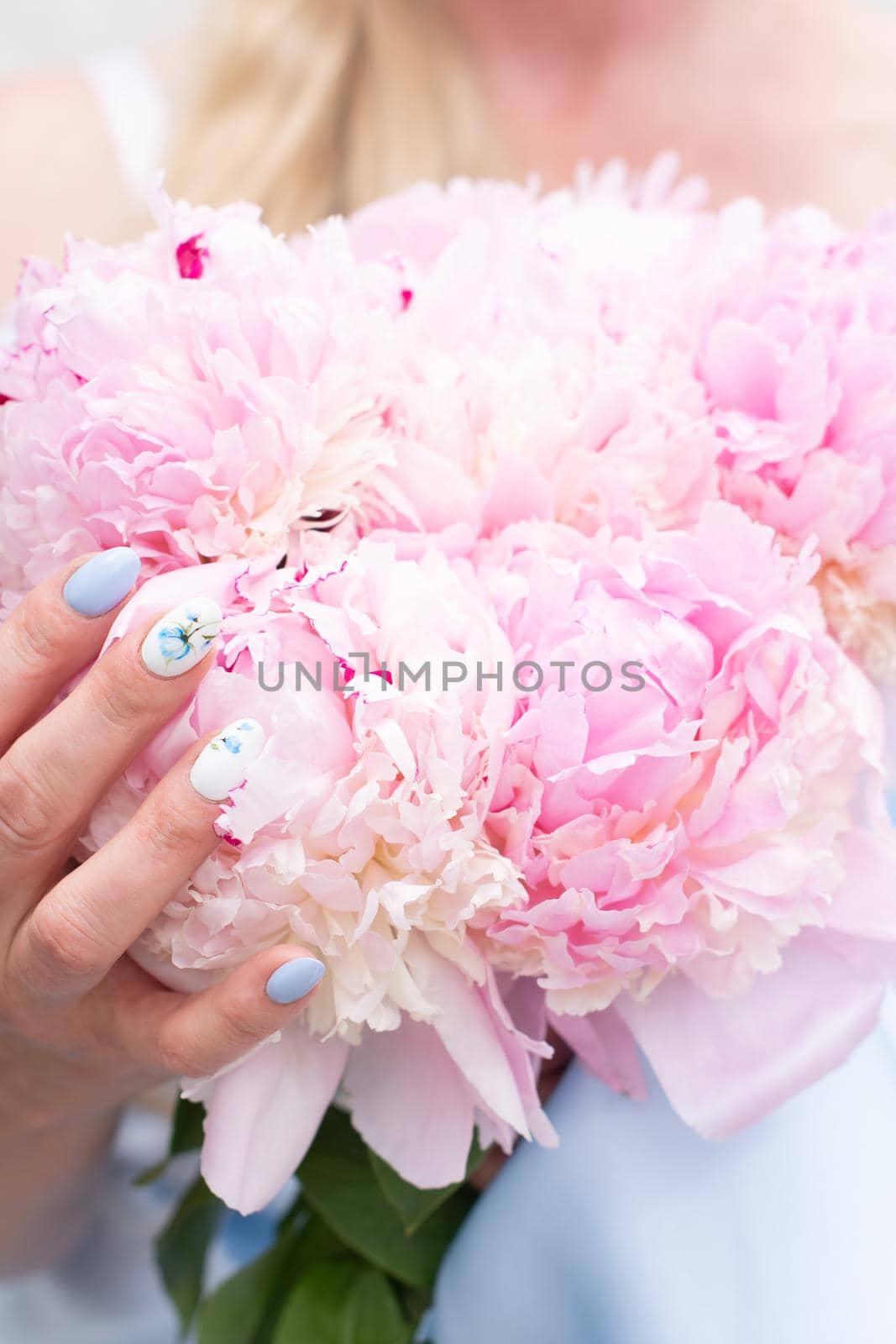 bride in a blue wedding dress with a bouquet of pink peonies, pastel paradise, floral background, complementary color combination. High quality photo