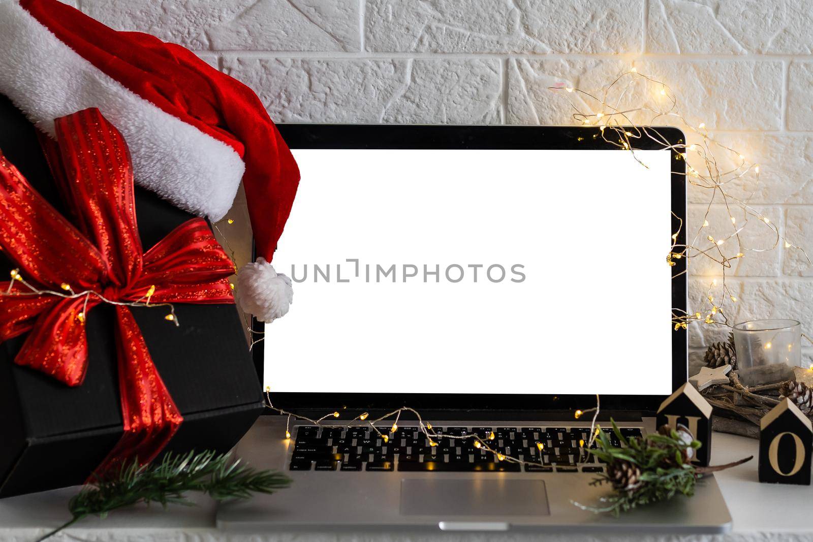 Blank display screen laptop computer. Modern cozy comfortable home living room with Christmas decor. Home office desk workspace by Andelov13