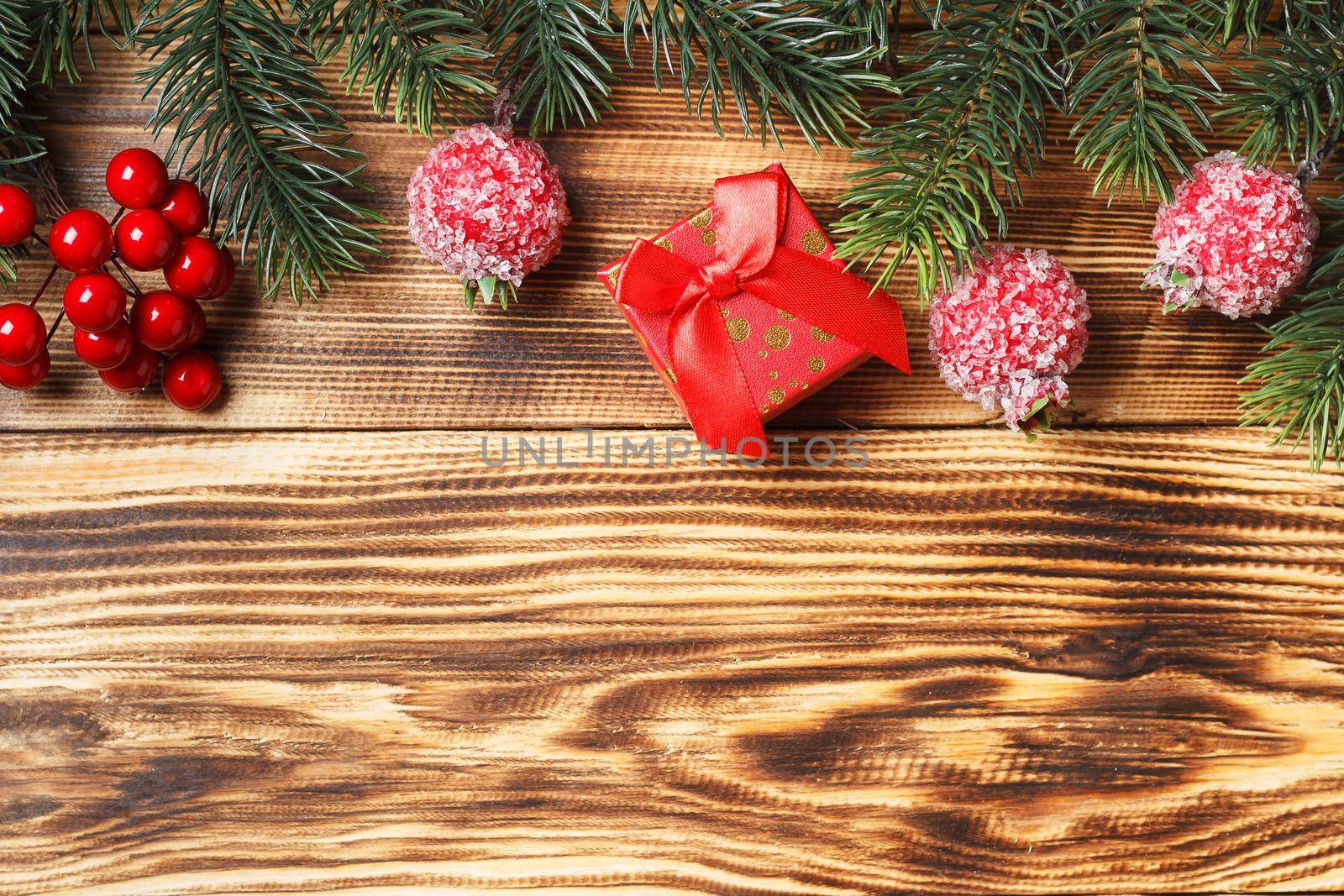 christmas wooden background of fir branches and toys. copy space