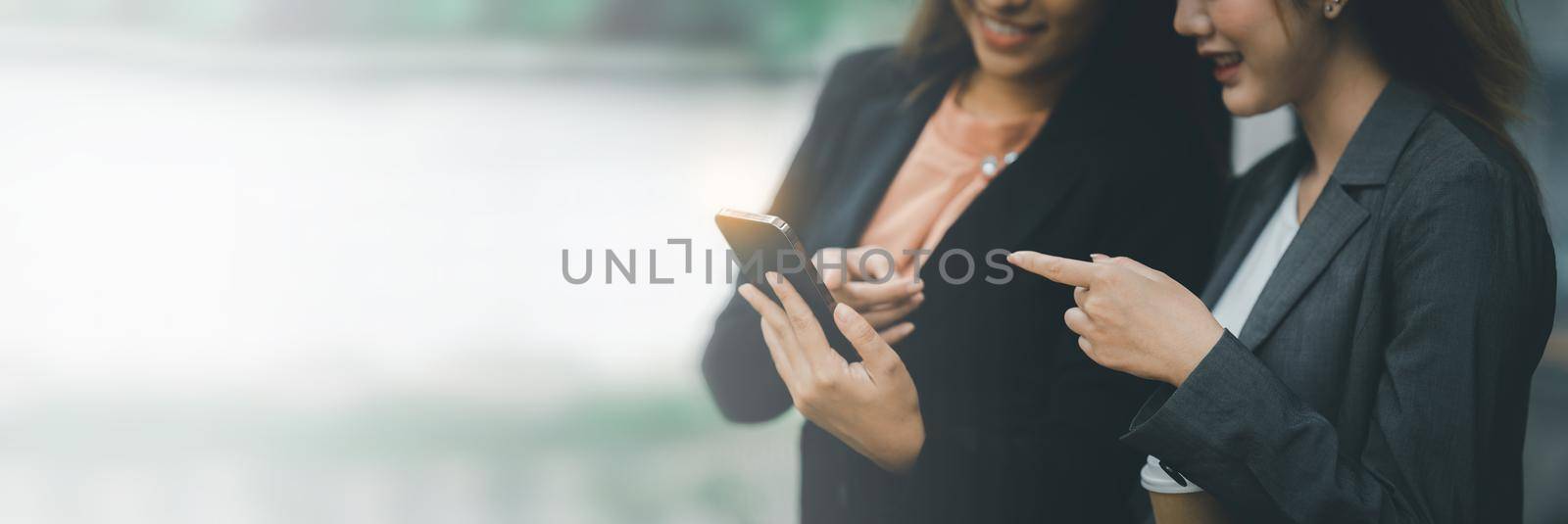 Two Asian businesswoman have video call meeting with partner by Mobile phone by itchaznong