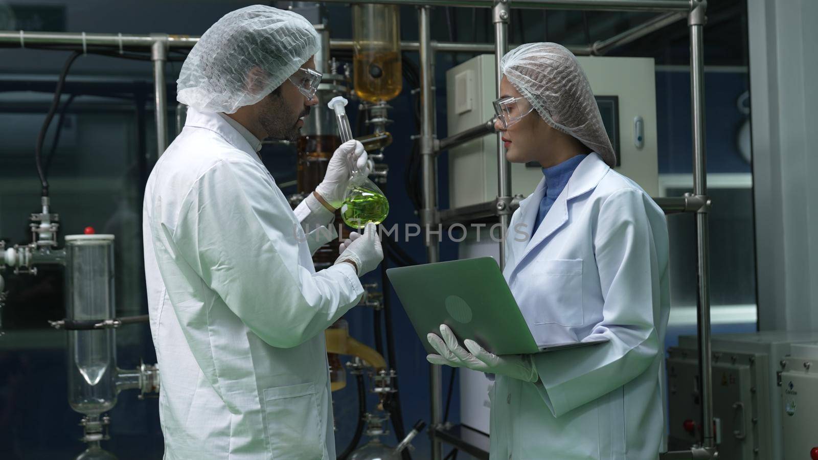 Two scientist in professional uniform working in laboratory for chemical and biomedical experiment