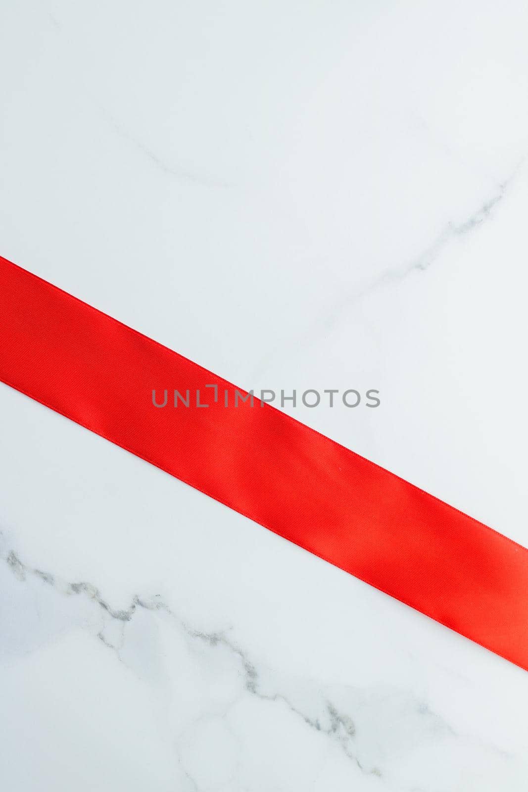 Holiday decor, feminine design and flatlay concept - Red silk ribbon on marble, top view