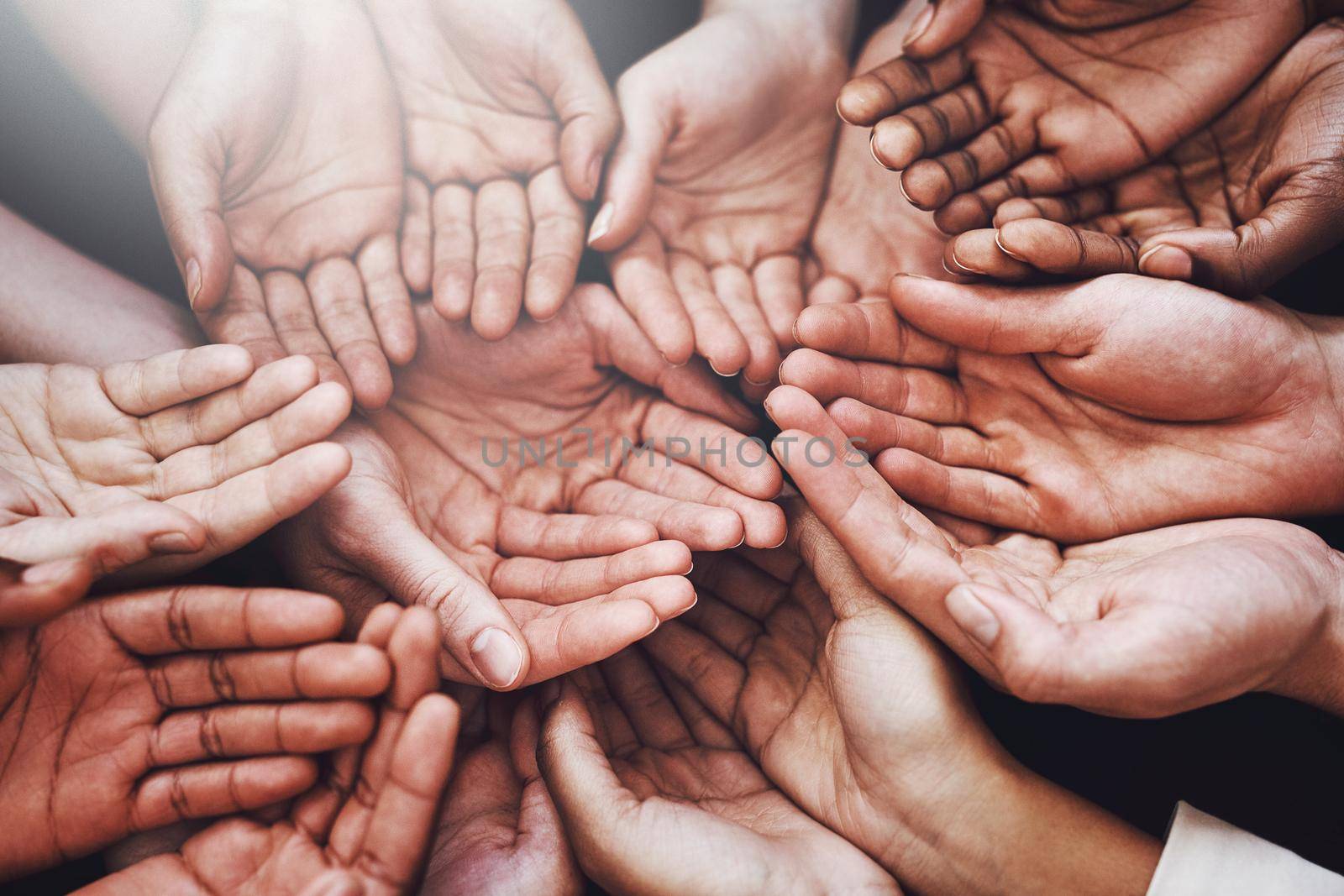 Help those in need. a group of hands held cupped out together. by YuriArcurs
