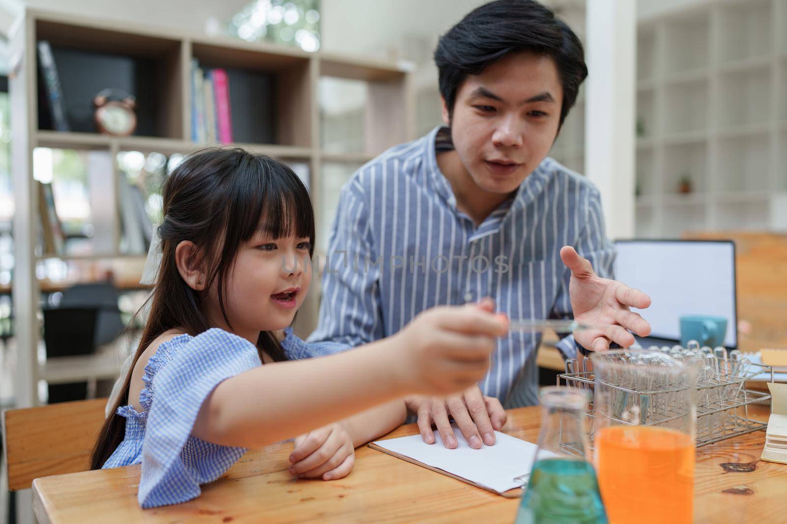Kid and teacher doing science experiments. back to school concept.
