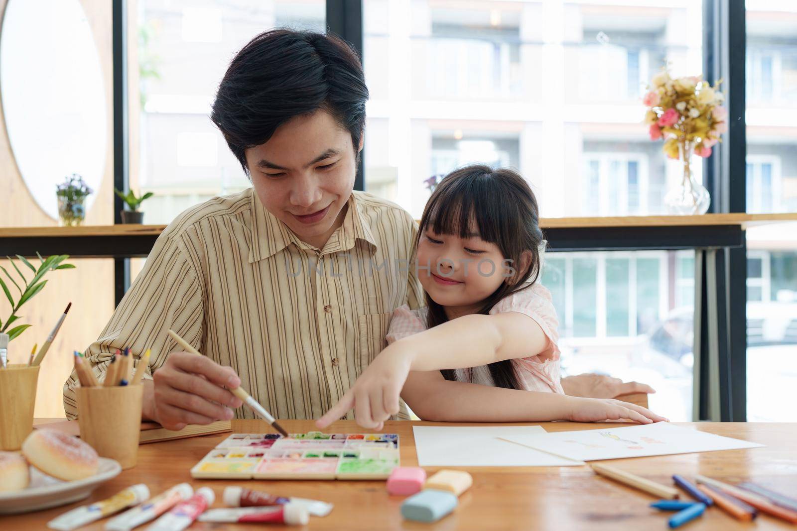 A happy kid and this father painting at home. Handmade skills training by itchaznong