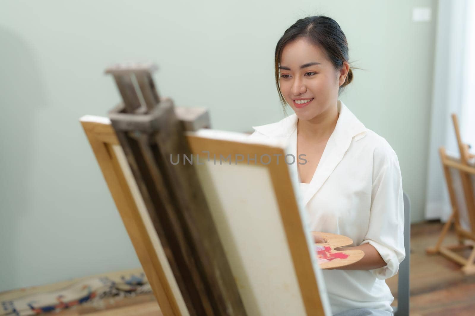 Portrait of an Asian woman designing art in her spare time. by Manastrong