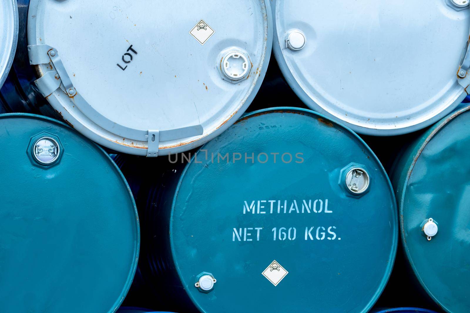 Old chemical barrels. Stack of blue methanol or methyl alcohol drum. Steel chemical tank. Toxic waste. Chemical barrel with toxic warning symbol. Industrial waste in drum. Hazard waste storage. by Fahroni