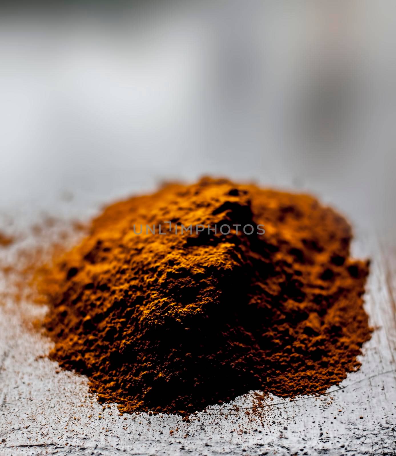Shot of raw revand chini powder on a wooden surface. Shot in dark gothic colors.