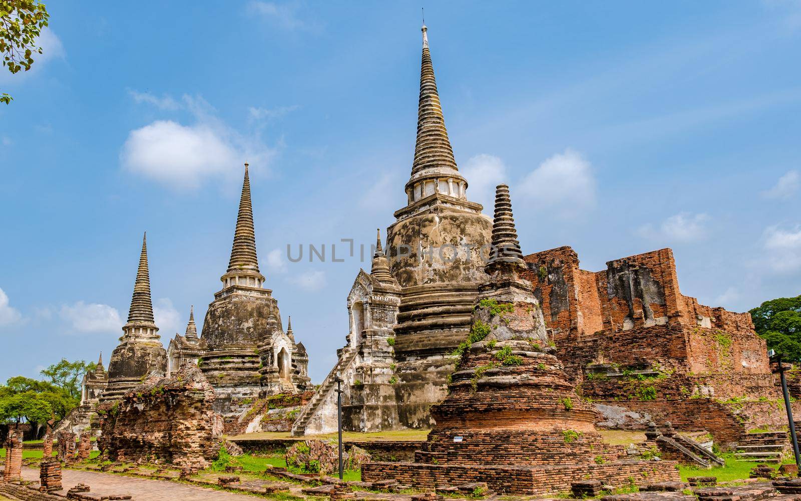Ayutthaya, Thailand at Wat Phra Si Sanphet, couple men and women with a hat visiting Ayyuthaya Thailand by fokkebok