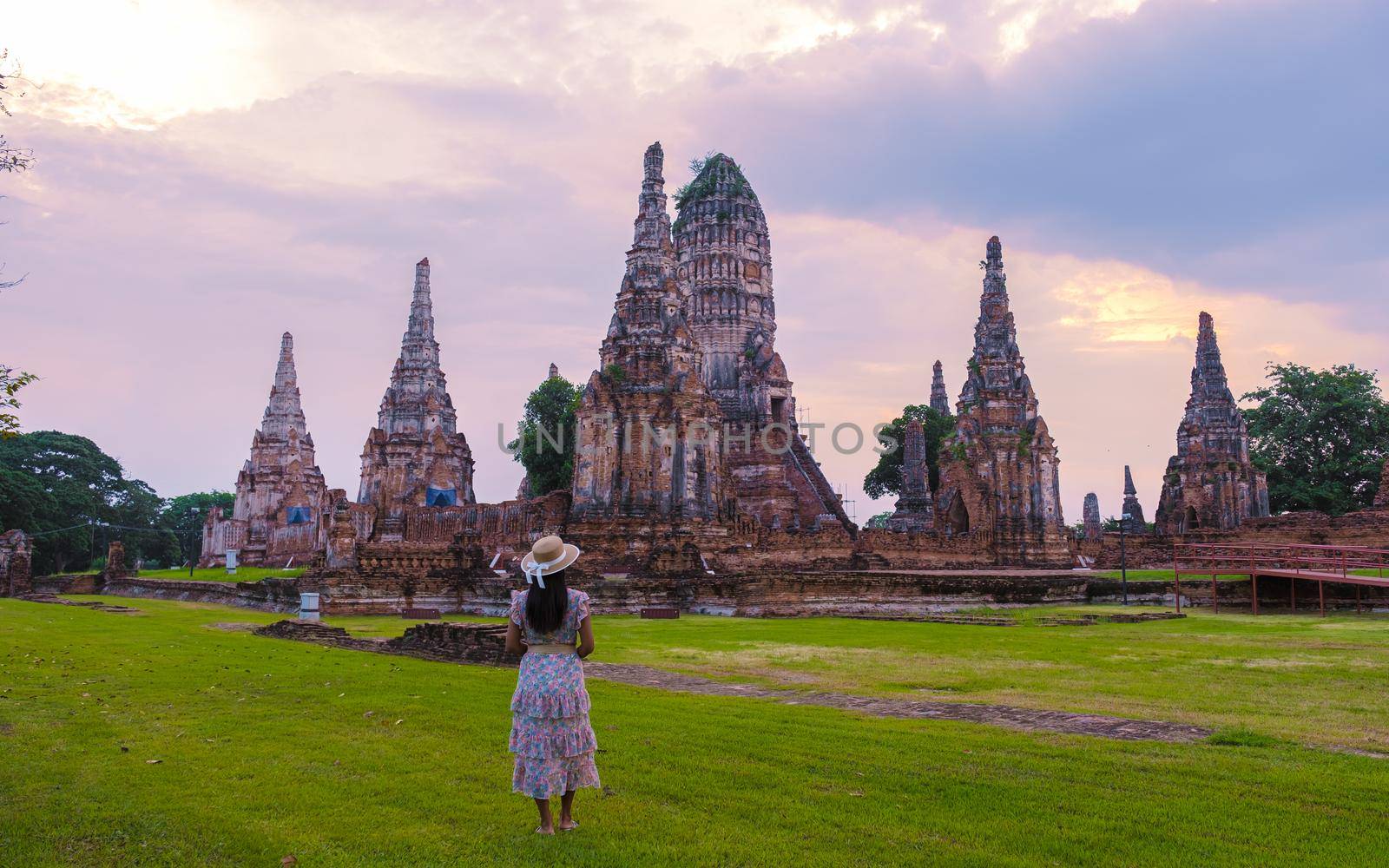 Ayutthaya, Thailand at Wat Chaiwatthanaram during sunset in Ayutthaya Thailand, Asian women with hat visiting a temple