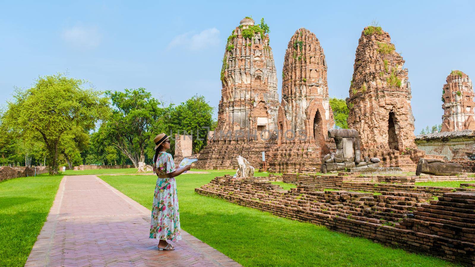 Ayutthaya, Thailand at Wat Mahathat, women with a hat and tourist map visiting Ayyuthaya Thailand by fokkebok