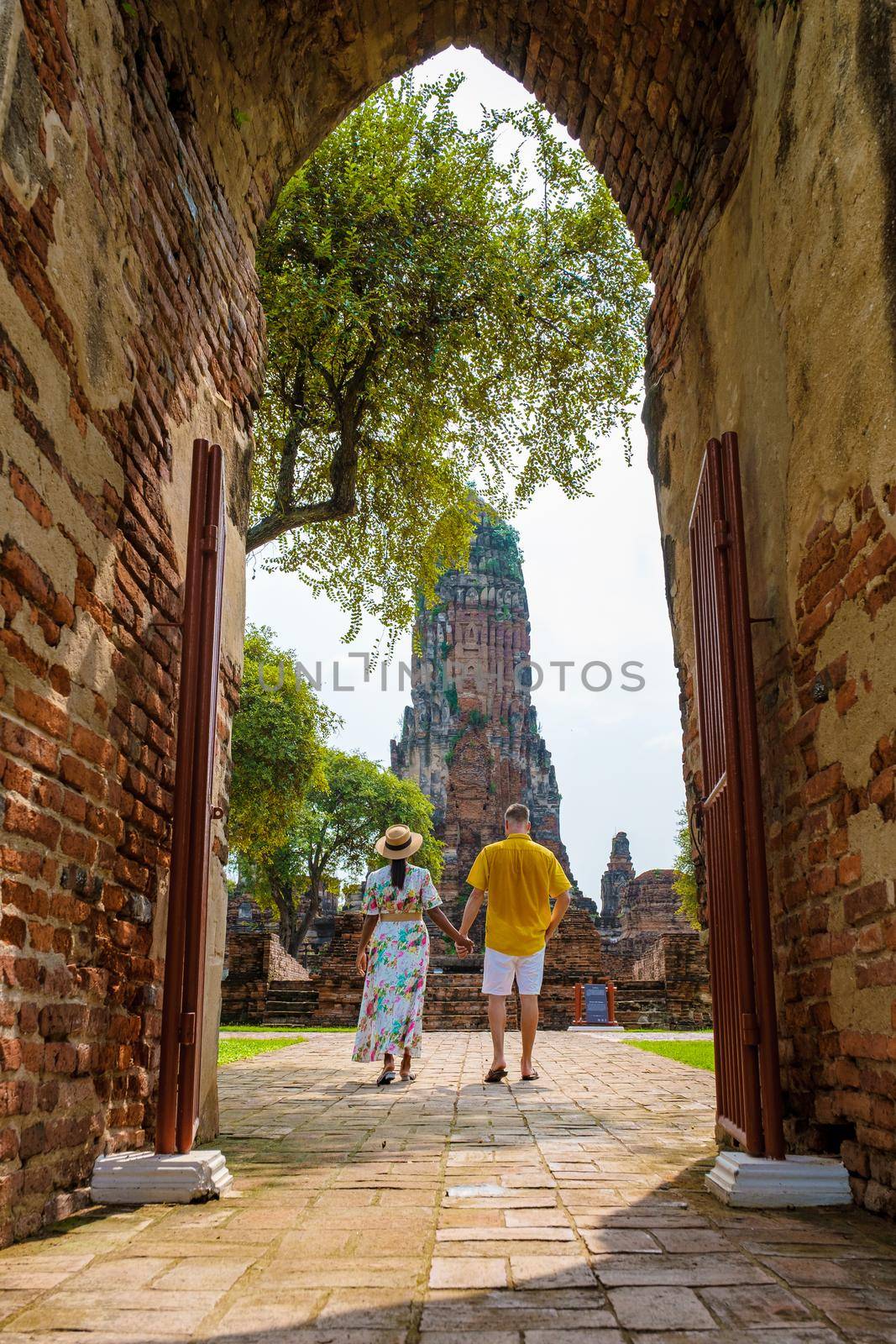 Ayutthaya, Thailand at Wat Phra Ram, a couple of men and women with a hat visiting Ayyuthaya Thailand. Tourist with map in Thailand