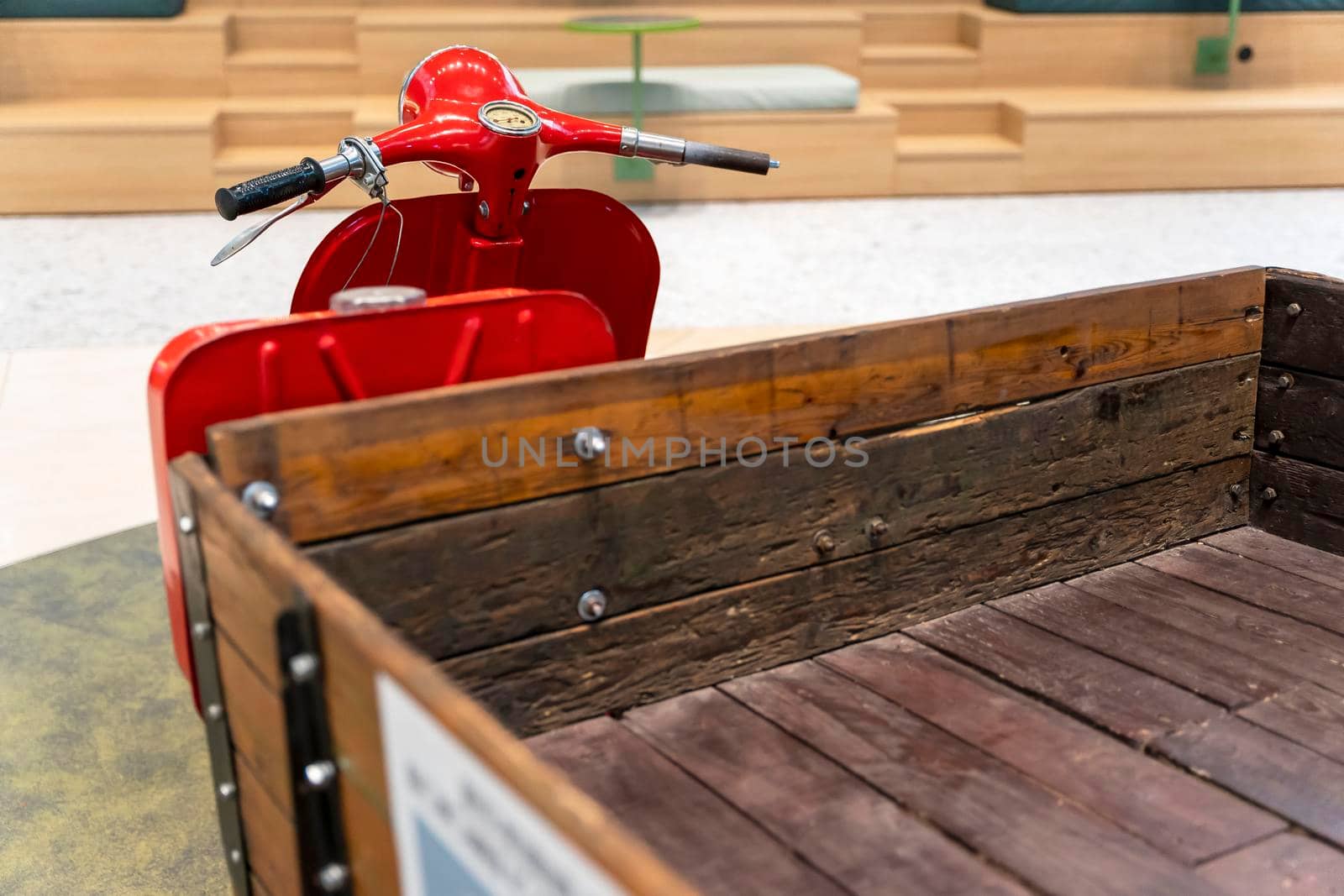 vintage old three-wheeled cargo scooter with wooden body. retro scooter for the delivery of goods and delivery to small shops and farms.