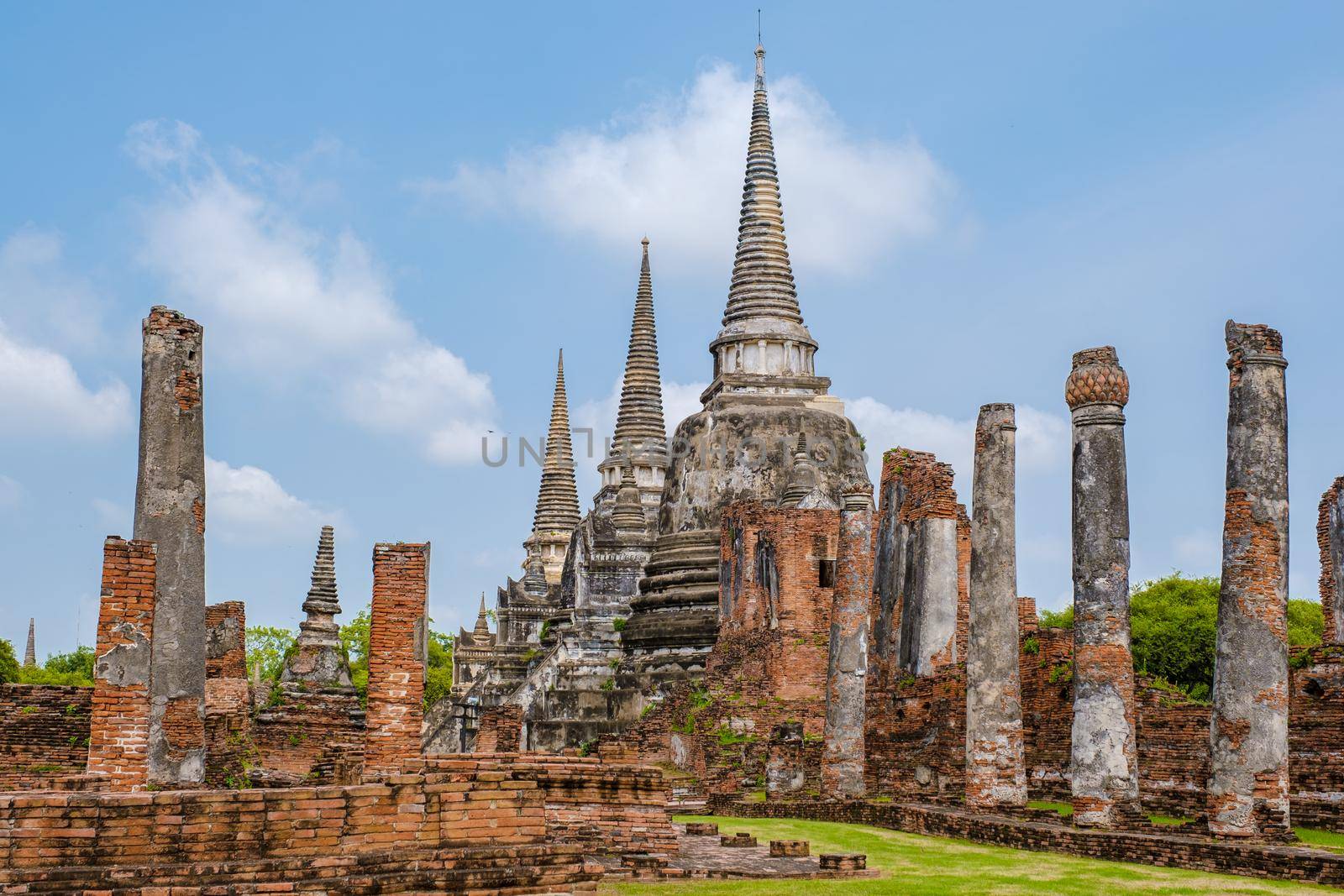 Ayutthaya, Thailand at Wat Phra Si Sanphet, couple men and women with a hat visiting Ayyuthaya Thailand by fokkebok