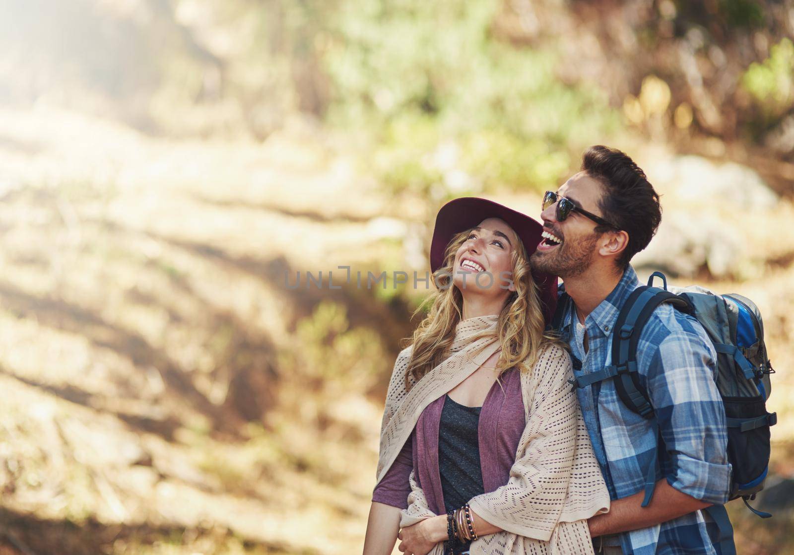 Taking in the beauty of nature. an affectionate young couple during a hike. by YuriArcurs