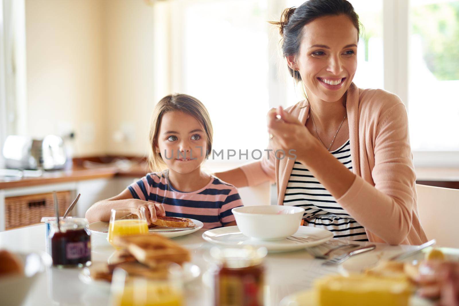 Great days begin with family breakfasts. a family having breakfast together. by YuriArcurs