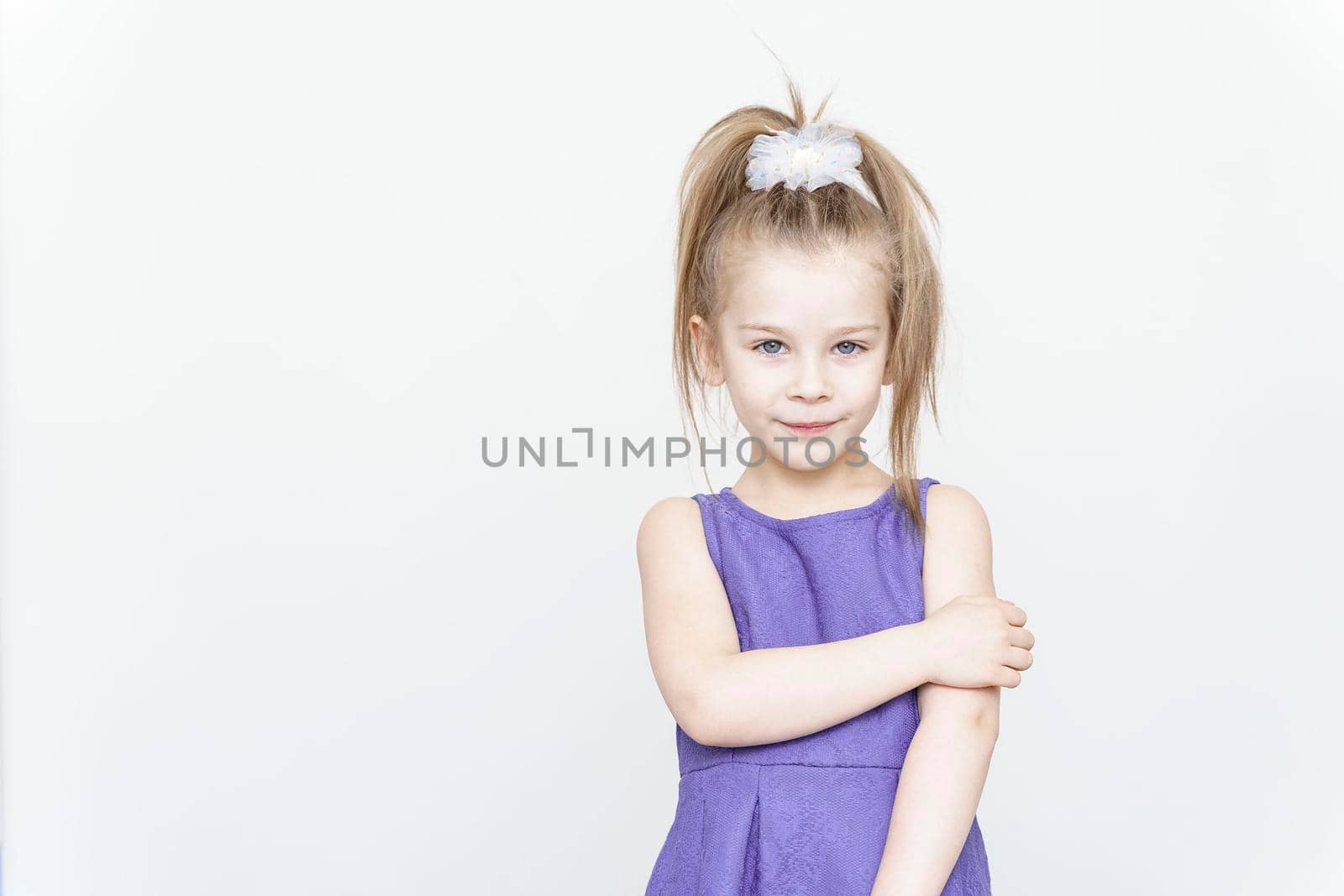 portrait of a cute 5 year old girl on a light background