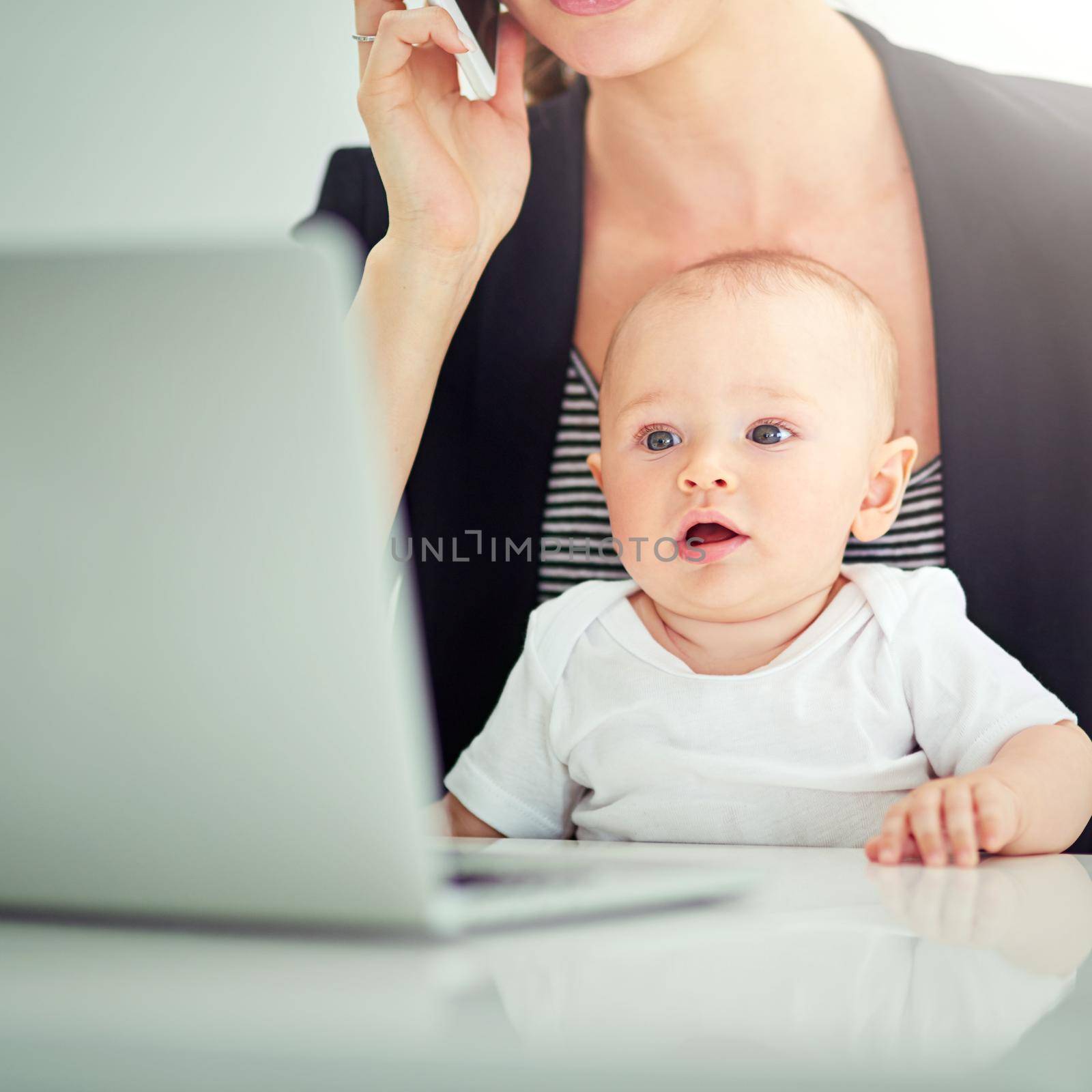 So this is work, huh. an adorable baby boy curious about his mothers work on her computer. by YuriArcurs