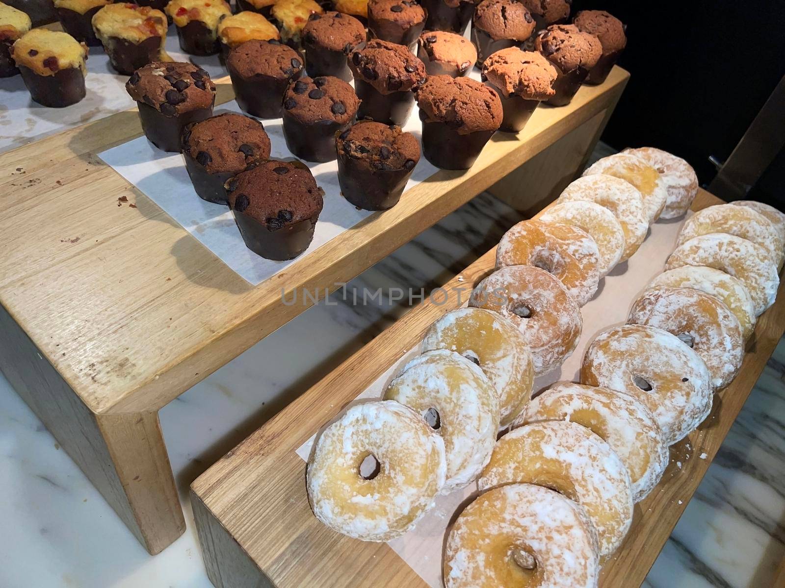 Lines of fresh delicious donuts on bakery shop, tasty multiple donuts, Selective focus donuts with various topping