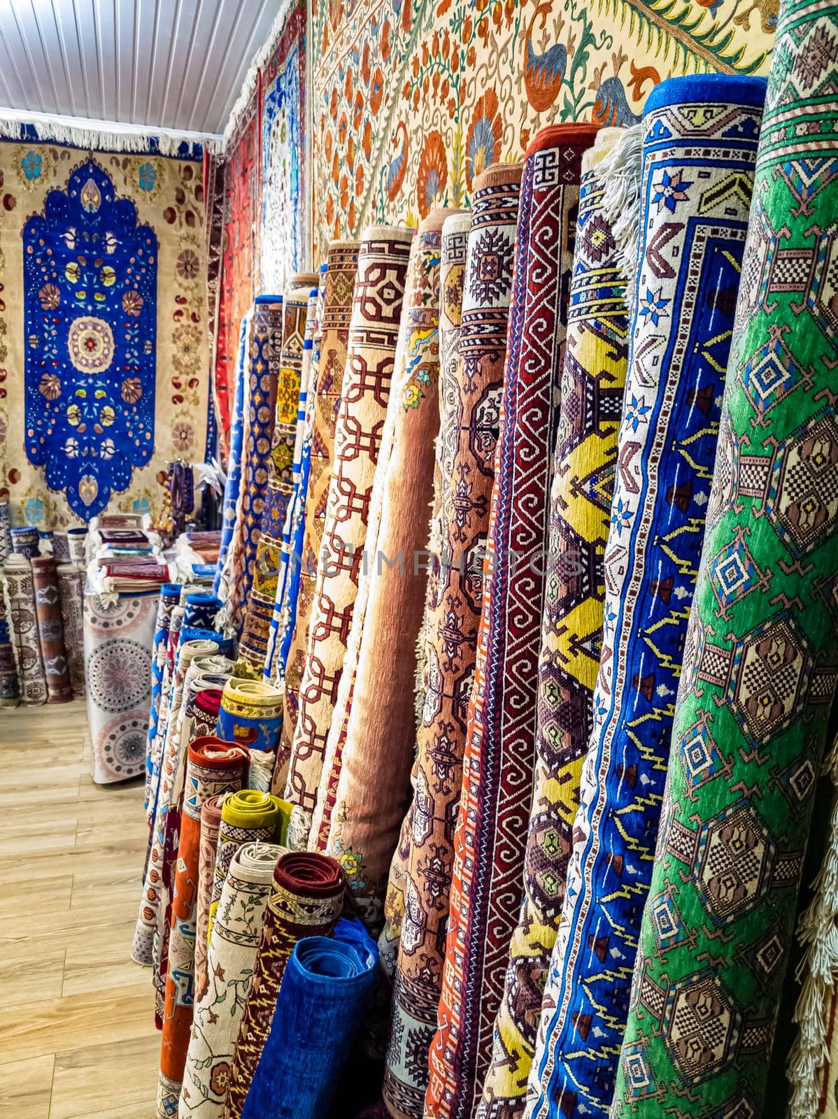 Ethnic carpet, ornamental folk bags, many ornate pillows with embroidery in asian shop, store. Asian market, trade fair in Uzbekistan. Traditional national ornament. Asian handicraft, Uzbek craft by Milanchikov