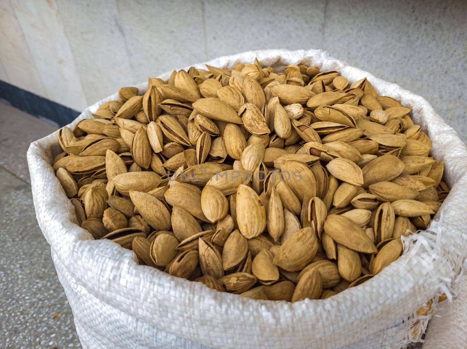 Oriental Bazaar. Almond peeled and unpeeled, nuts sales in market. Dry food, variety almonds in store. Concept of healthy eating, raw product, bazaar, diet, almond theme by Milanchikov